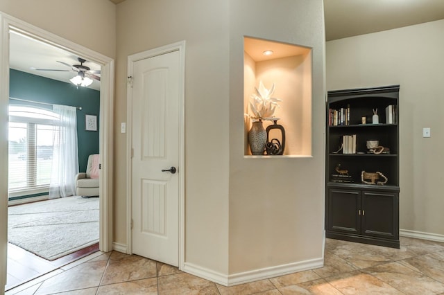 hall featuring light tile patterned floors