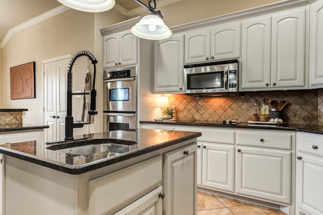 kitchen with ornamental molding, stainless steel appliances, and white cabinets