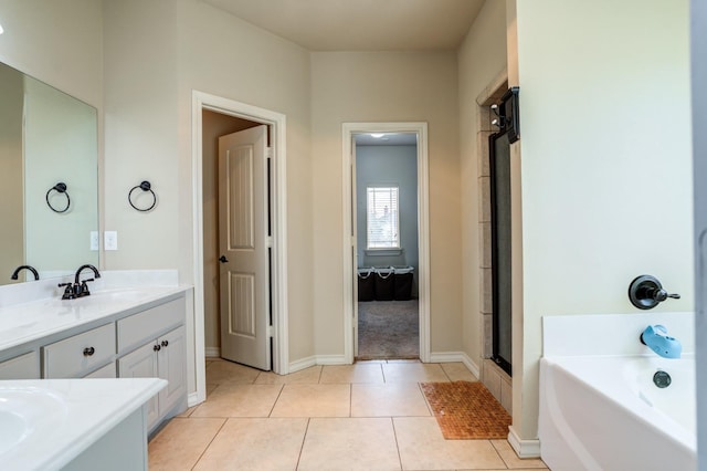 bathroom with vanity, tile patterned floors, and a bathing tub