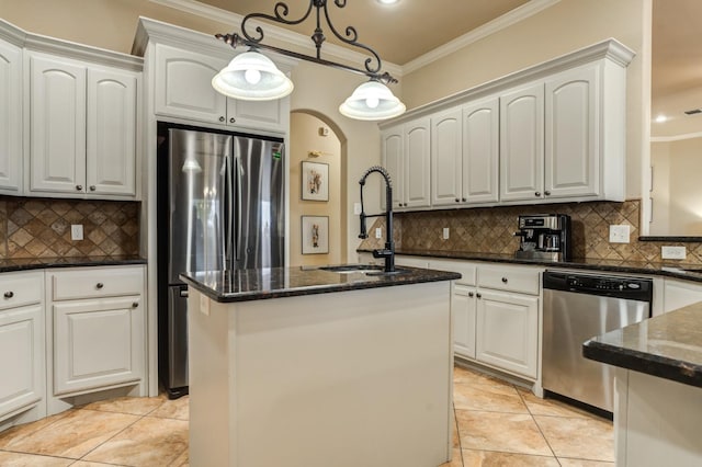 kitchen featuring pendant lighting, white cabinetry, a center island with sink, and appliances with stainless steel finishes