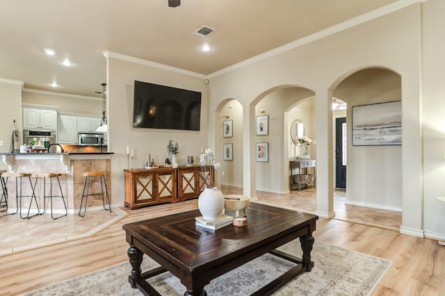 living room with crown molding and light wood-type flooring