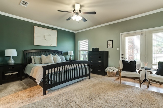 bedroom with ornamental molding, light carpet, and ceiling fan