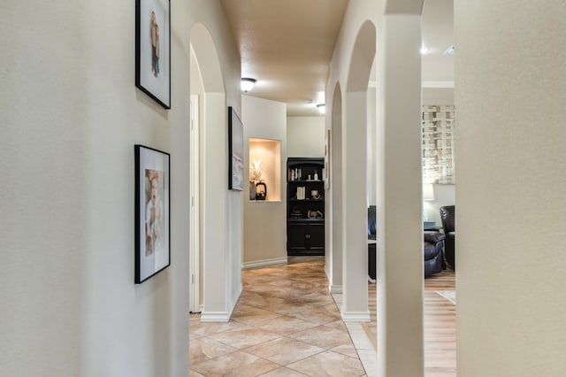 corridor with light tile patterned flooring