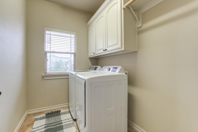 laundry room featuring cabinets and washing machine and dryer