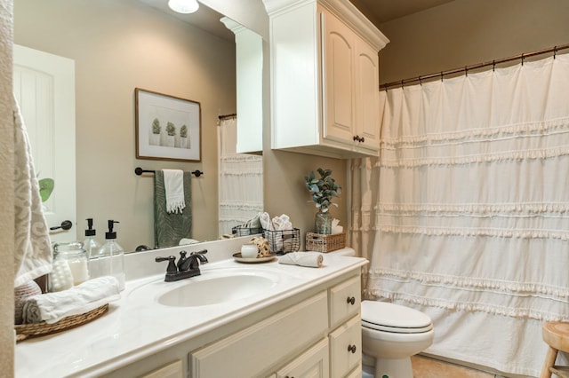 bathroom featuring vanity and toilet