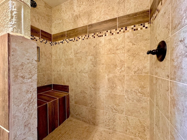 bathroom with tiled shower