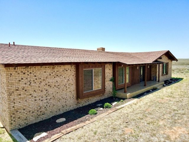 view of property exterior with a patio