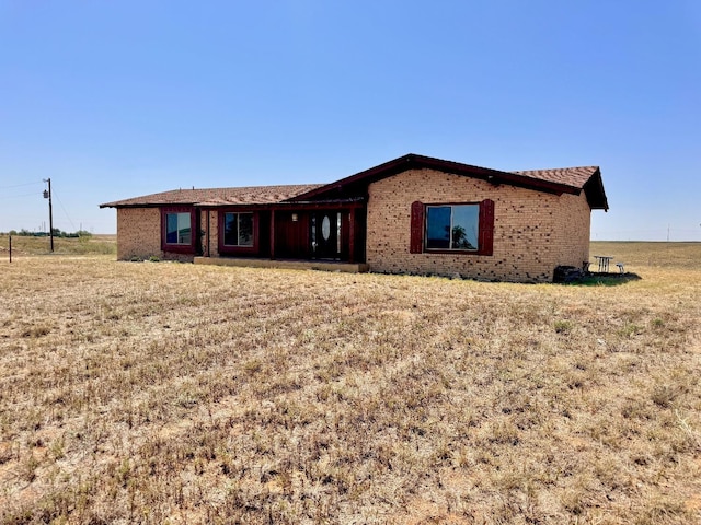 rear view of property with a lawn