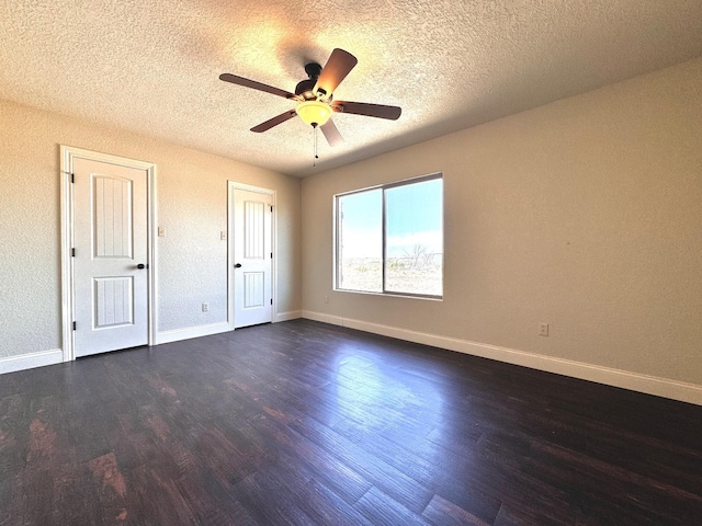 unfurnished bedroom with ceiling fan, dark hardwood / wood-style floors, and a textured ceiling