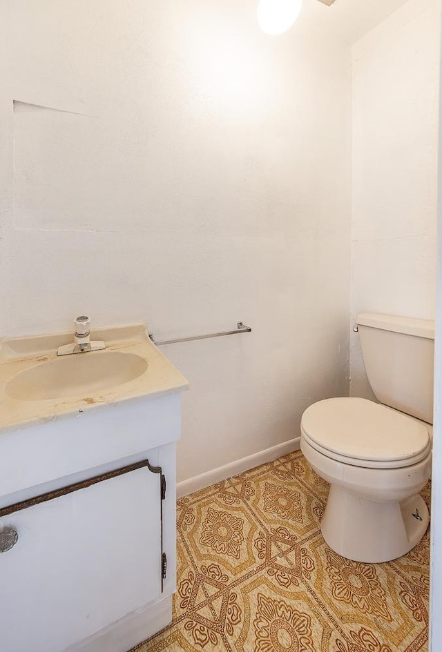 bathroom with tile patterned flooring, vanity, and toilet