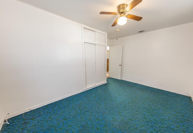 unfurnished bedroom featuring a closet, ceiling fan, and dark colored carpet