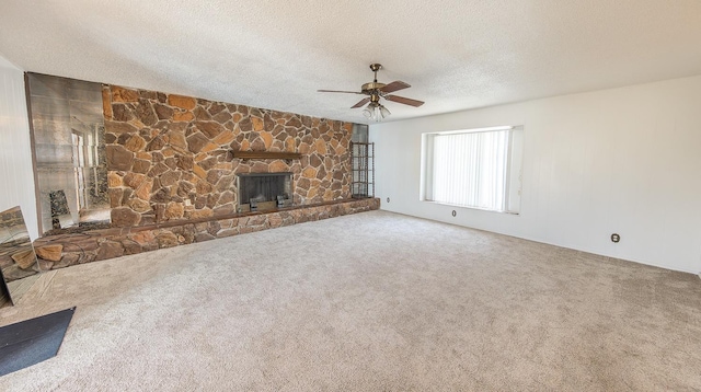 unfurnished living room with ceiling fan, carpet, a textured ceiling, and a fireplace