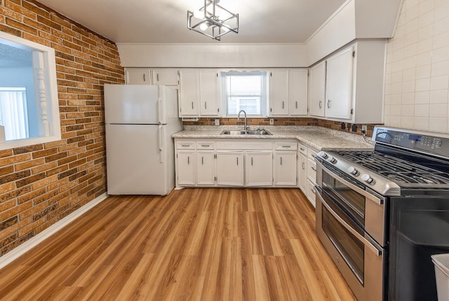 kitchen featuring brick wall, white cabinetry, sink, double oven range, and white fridge