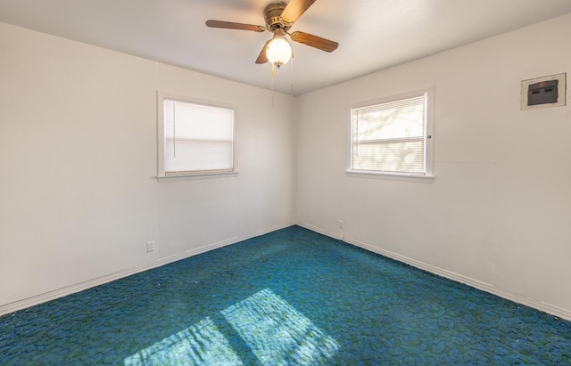 spare room featuring ceiling fan and carpet floors