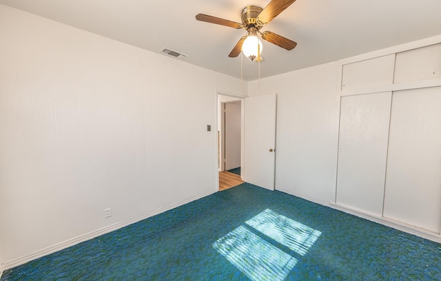 unfurnished bedroom featuring light carpet, a closet, and ceiling fan