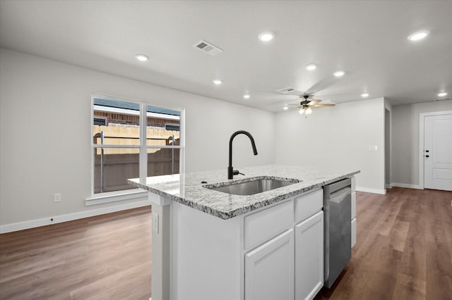 kitchen featuring sink, hardwood / wood-style flooring, dishwasher, a kitchen island with sink, and white cabinets