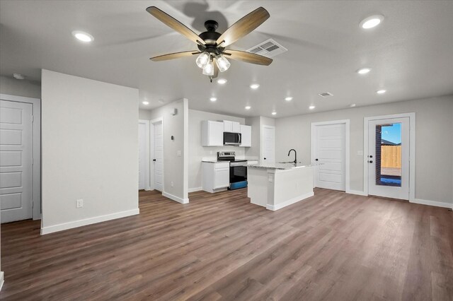 kitchen with sink, white cabinetry, dark hardwood / wood-style floors, an island with sink, and stainless steel appliances