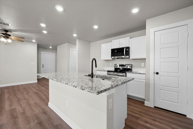 kitchen with white cabinetry, appliances with stainless steel finishes, sink, and a center island with sink