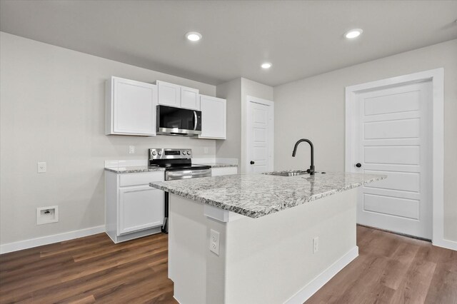 kitchen featuring an island with sink, appliances with stainless steel finishes, sink, and white cabinets