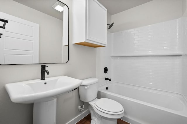 bathroom with shower / washtub combination, hardwood / wood-style floors, and toilet