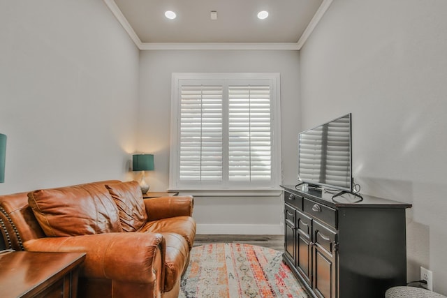 living area with ornamental molding and light hardwood / wood-style flooring