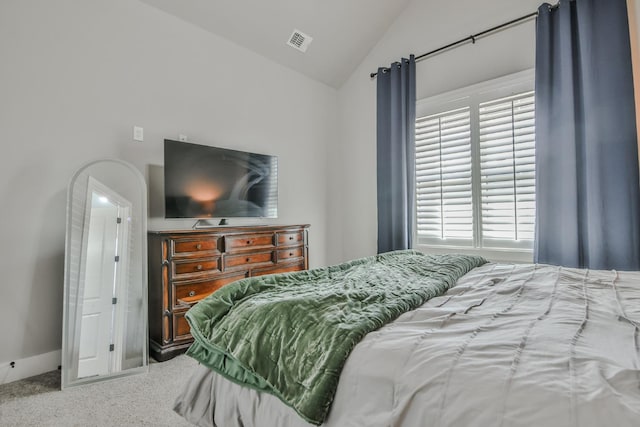 carpeted bedroom with lofted ceiling