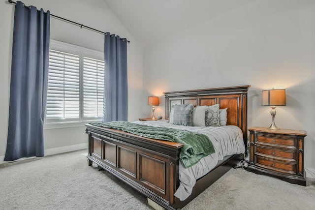 carpeted bedroom with vaulted ceiling