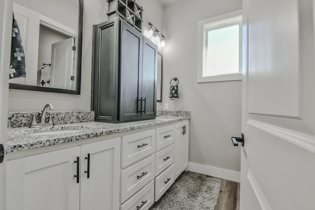 bathroom featuring vanity and hardwood / wood-style floors