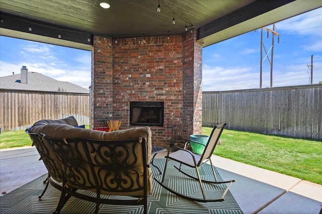 view of patio with an outdoor brick fireplace