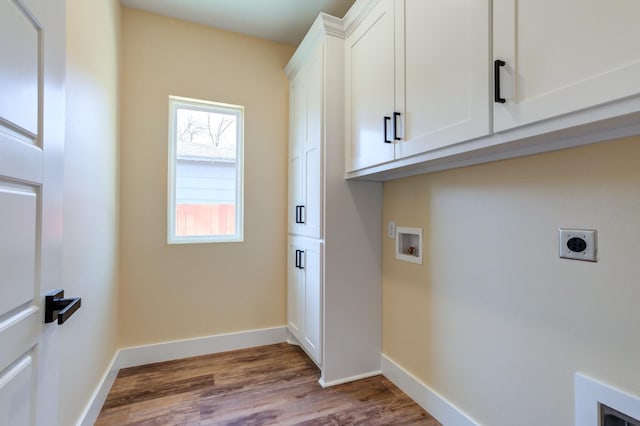 laundry room featuring cabinets, hookup for an electric dryer, hookup for a washing machine, and light wood-type flooring