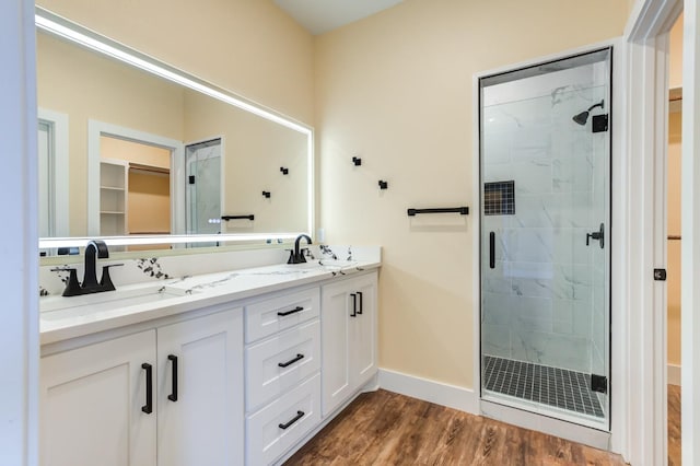 bathroom featuring an enclosed shower, vanity, and hardwood / wood-style flooring