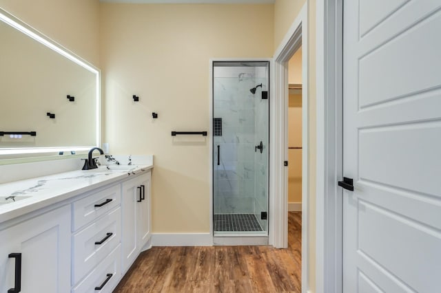 bathroom with vanity, wood-type flooring, and walk in shower