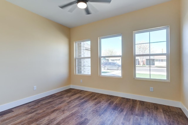 empty room featuring dark hardwood / wood-style flooring and ceiling fan