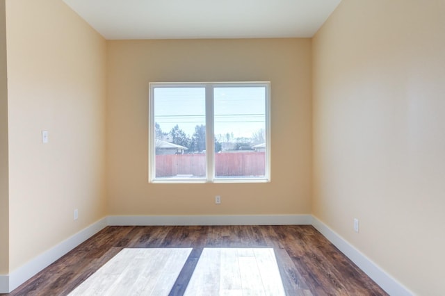 spare room featuring dark hardwood / wood-style flooring