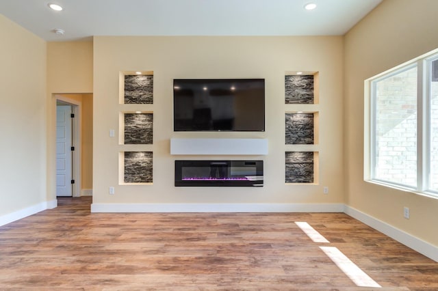 unfurnished living room featuring hardwood / wood-style flooring