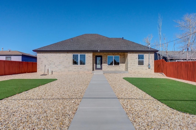 back of house featuring a lawn