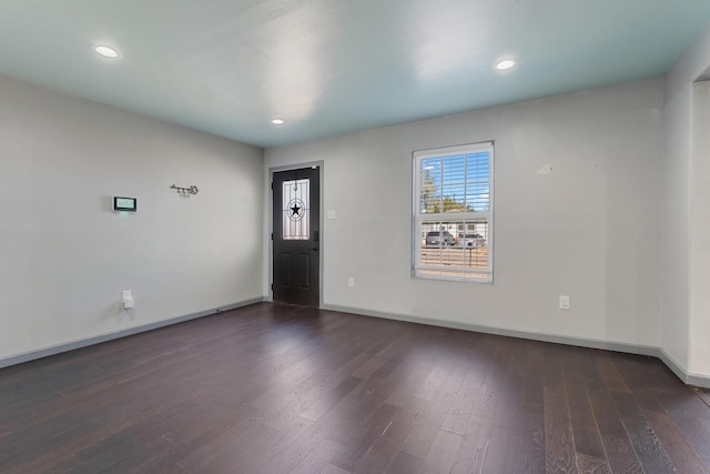unfurnished room with dark wood-type flooring
