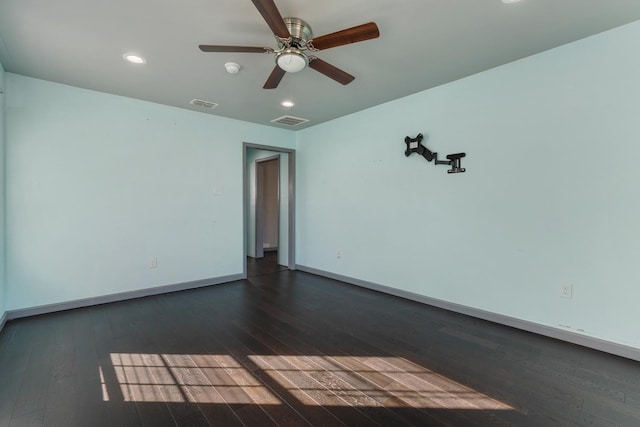spare room featuring dark wood-type flooring and ceiling fan