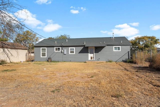 back of property with a lawn