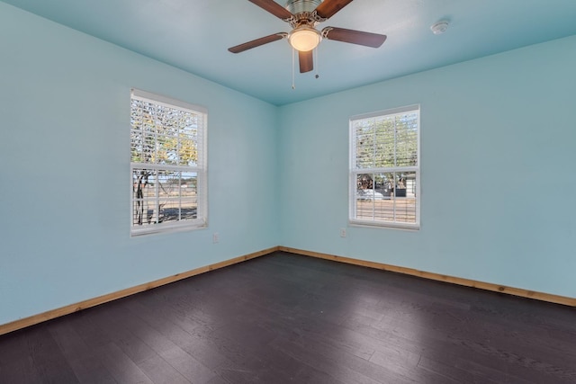 unfurnished room featuring ceiling fan and dark hardwood / wood-style flooring
