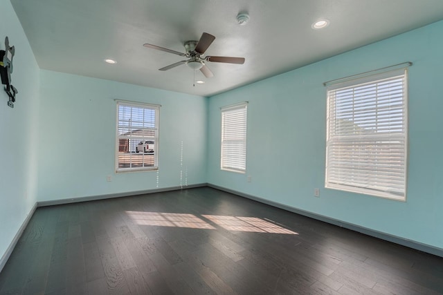 empty room featuring ceiling fan and dark hardwood / wood-style flooring