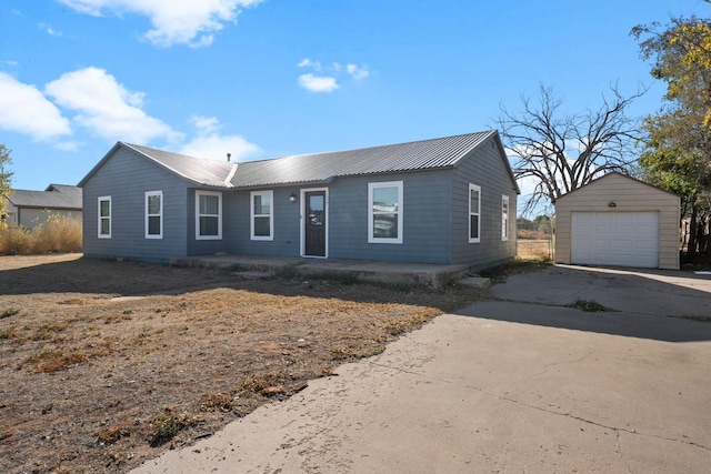 ranch-style home with an outbuilding and a garage