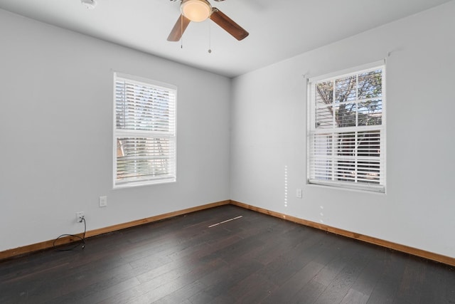 spare room featuring plenty of natural light, dark hardwood / wood-style floors, and ceiling fan