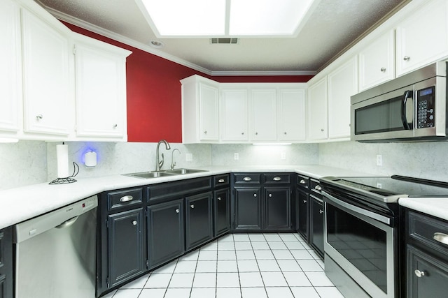 9613 Vicksburg Ave, Lubbock, TX 79424 - kitchen with appliances with stainless steel finishes, white cabinets, dark cabinets, and crown molding
