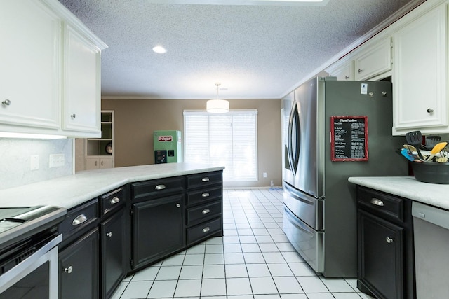 9613 Vicksburg Ave, Lubbock, TX 79424 - kitchen featuring appliances with stainless steel finishes, white cabinets, a peninsula, light countertops, and ornamental molding