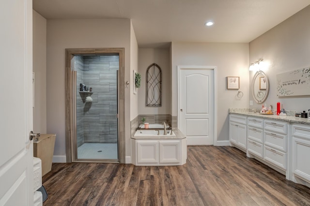 4902 Marshall St, Lubbock, TX 79416 - bathroom with a stall shower, a bath, double vanity, wood finished floors, and recessed lighting