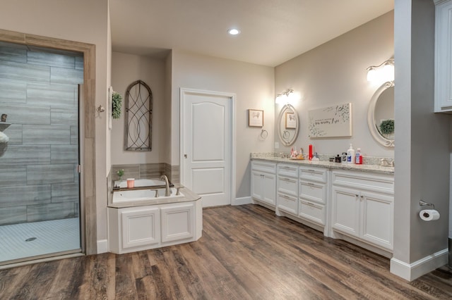 4902 Marshall St, Lubbock, TX 79416 - bathroom with double vanity, a garden tub, a shower stall, wood finished floors, and recessed lighting