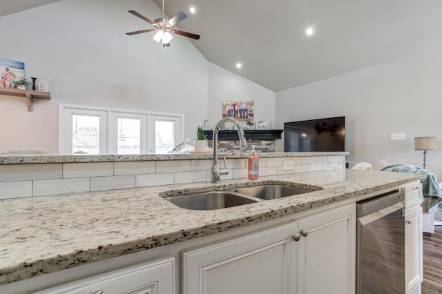 4902 Marshall St, Lubbock, TX 79416 - kitchen featuring stainless steel dishwasher, high vaulted ceiling, light stone countertops, a ceiling fan, and dark wood-type flooring