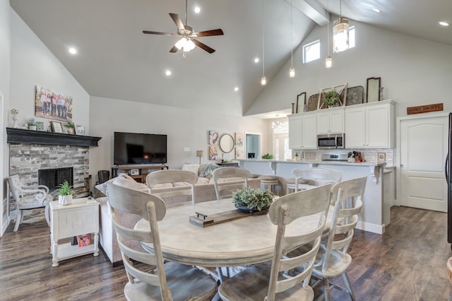 4902 Marshall St, Lubbock, TX 79416 - dining space with high vaulted ceiling, healthy amount of natural light, dark wood finished floors, a ceiling fan, and a fireplace
