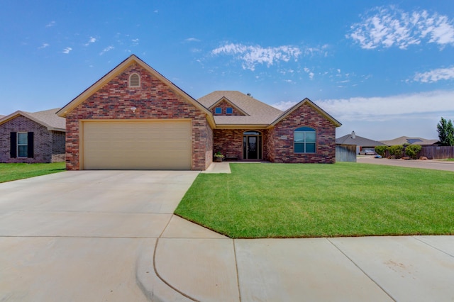 4902 Marshall St, Lubbock, TX 79416 - view of front of property with an attached garage, a front yard, brick siding, and driveway